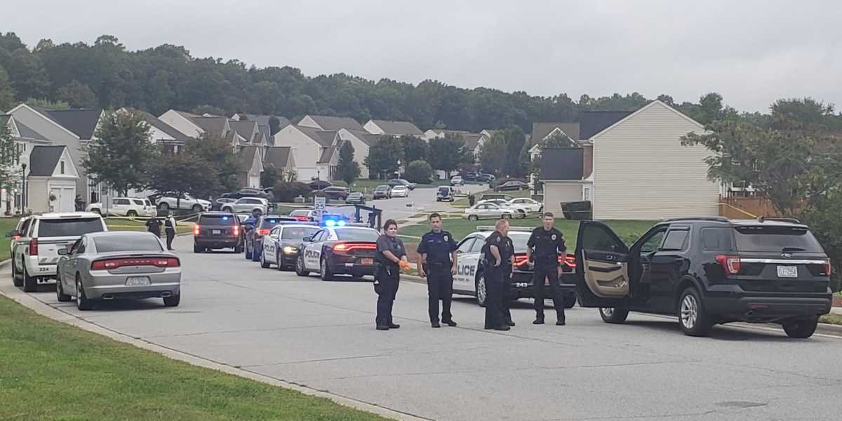 One person is in custody and two others are wanted by authorities after someone fired a gun at an officer's face early Tuesday morning in High Point, 